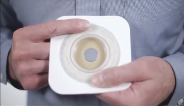 a person holding a white cup